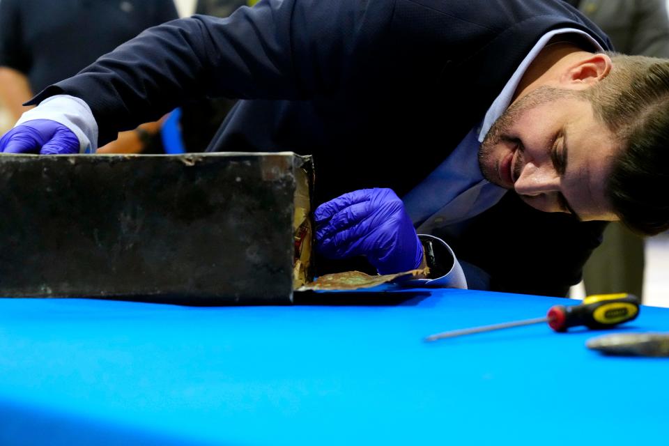 Little Ferry Mayor Mauro Raguseo, looks into the 1914 time capsule seconds after it was opened, Sunday, March 3, 2024.