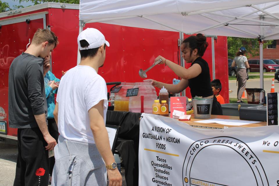 People wait for their order from Choco Fresa Sweets & La Madre Café at South District's Diversity Market, May 28.