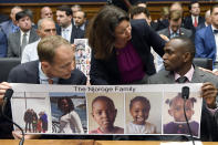 Rep. Angela Craig, D-Minn., center, talks with Paul Njoroge, right, as Michael Stumo, left, looks on before the start of a House Transportation subcommittee hearing on Capitol Hill in Washington, Wednesday, July 17, 2019, on aviation safety. Njoroge lost his wife and three young children on Ethiopian Airlines Flight 302 and Stumo lost his daughter on the same flight. The plane was a Boeing 737 MAX. (AP Photo/Susan Walsh)