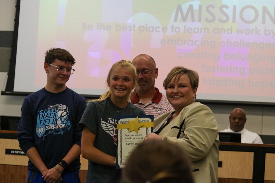 Salina Central sophomore Katelyn Rupe is shown with Superintendent Exline Tuesday. Rupe earned state champion honors in both the 1600 meter and 3200 meter races last spring.