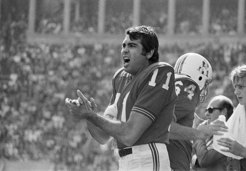 Boston Patriots quarterback Joe Kapp shouts to teammates from the sidelines during a 1970 game