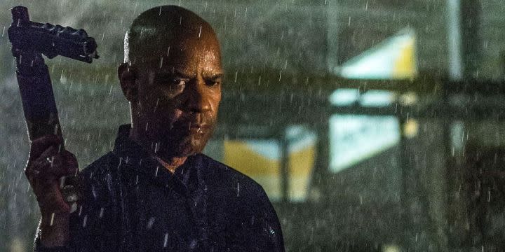 Denzel Washington holds up his gun in The Equalizer