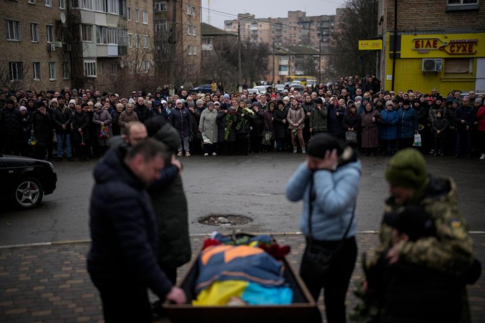 Bucha relatives gather to mourn Oleksiy Zavadskyi, a Ukrainian serviceman who died in combat on Jan. 15 in Bakhmut, during his funeral in Bucha, Ukraine, on Jan. 19.<span class="copyright">Daniel Cole—AP</span>