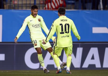 Barcelona's Neymar (L) celebrates next to team mate Lionel Messi after scoring a goal against Atletico Madrid during their Spanish King's Cup quarterfinal second leg soccer match at Vicente Calderon stadium in Madrid January 28, 2015. REUTERS/Sergio Perez