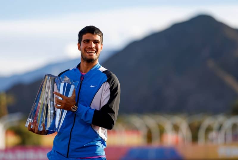 Spanish tennis player Carlos Alcaraz celebrates with the trophy after defeating Russia's Daniil Medvedev during their Men's final tennis match of the BNP Paribas Open tennis tournament at Indian Wells Tennis Garden. Charles Baus/CSM via ZUMA Press Wire/dpa