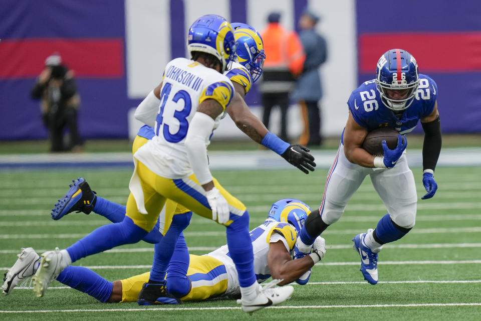 New York Giants running back Saquon Barkley (26) runs the ball during the first half an NFL football game against the Los Angeles Rams, Sunday, Dec. 31, 2023, in East Rutherford, N.J. (AP Photo/Seth Wenig)