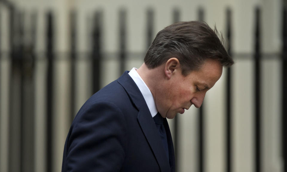 Britain's Prime Minister David Cameron walks back to number 10 through Downing Street in London, after arriving back from Prime Minister's Question at the Houses of Parliament, Wednesday, Nov. 28, 2012. The judge who spent a year investigating the misdeeds of Britain's lively newspapers is giving Prime Minister David Cameron an early look at his recommendations for the regulation of the press. Officials say Cameron will get a copy of Lord Justice Brian Leveson's report Wednesday, a day before the public sees it, but Cameron is already being besieged with advice about how to respond to the still-secret recommendations. (AP Photo/Matt Dunham)