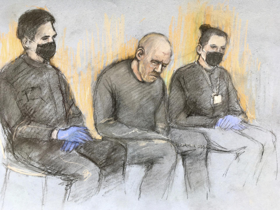This court artist sketch by Elizabeth Cook shows serving police constable Wayne Couzens, center appearing in the dock at Westminster Magistrates' Court, in London, Saturday, March 13, 2021. A serving British police officer accused of the kidnap and murder of a woman in London has appeared in court for the first time. Wayne Couzens, 48, is charged with kidnapping and killing 33-year-old Sarah Everard, who went missing while walking home from a friend’s apartment in south London on March 3. (Elizabeth Cook/PA via AP)