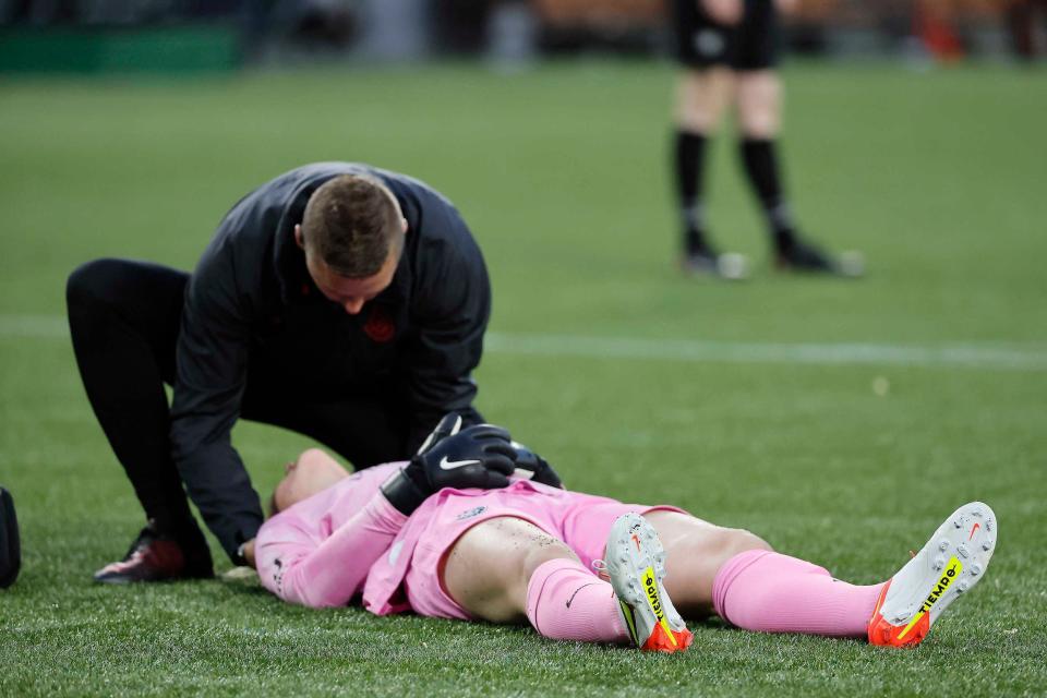 Pierre Soubrier treats an injured Thorns player.