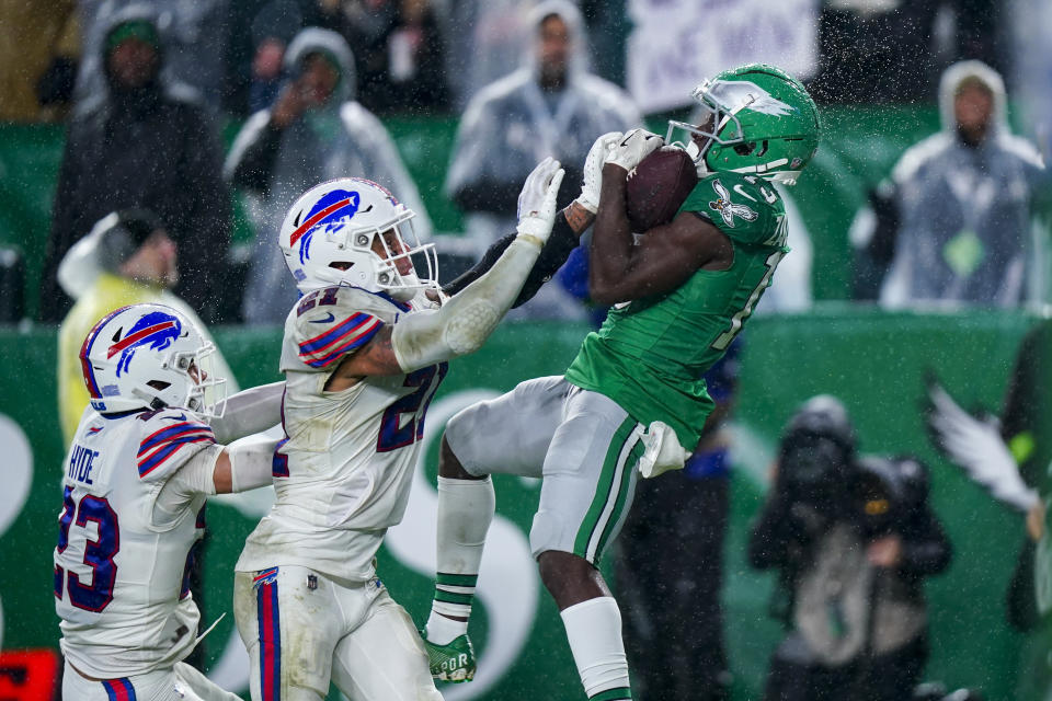 Philadelphia Eagles wide receiver Olamide Zaccheaus catches a touchdown pass over Buffalo Bills safety Micah Hyde and safety Jordan Poyer during the second half of an NFL football game Sunday, Nov. 26, 2023, in Philadelphia. (AP Photo/Chris Szagola)