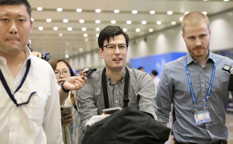 Australian student Alek Sigley smiles as he arrives at the airport in Beijing on Thursday, July 4, 2019. The Australian student who vanished in North Korea more than a week ago arrived in Beijing on Thursday morning. (Kyodo News via AP)