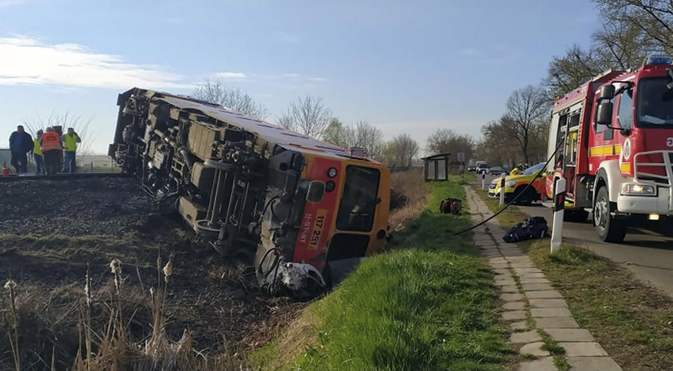 A derailed train carriage lies on its side after a fatal collision with a van in Mindszent, Hungary on Tuesday, April 5, 2022. Police say a train has struck a vehicle in southern Hungary and derailed, leaving several people dead and others injured. The accident occurred just before 7 a.m. in the town of Mindszent. (Csongrad-Csanad County Police via AP)