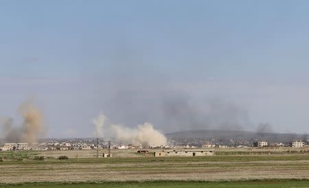 Smoke rises around the Syrian southern town of Bosra al-Sham March 24, 2015. REUTERS/Wsam Almokdad