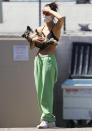 <p>Cara Santana cradles her puppy while out on a sunny Thursday in L.A.</p>