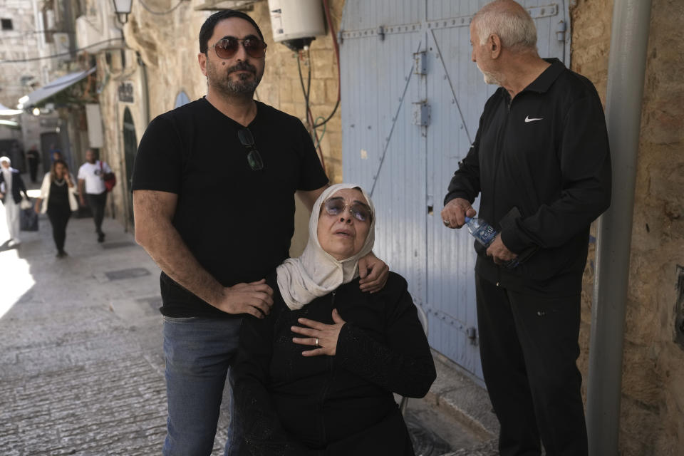 Nora Ghaith-Sub Laban, center, reacts to her family's eviction from their home to make way for Israeli settlers in Jerusalem's Old City, Tuesday, July 11, 2023. As the last remaining Palestinians in a building filled with settlers, the Ghaith-Sub Labans have battled Israeli attempts to evict them from their Old City home for over 45 years. Settlers claim the family are squatters who had been living in an apartment formerly owned by Jews. (AP Photo/Mahmoud Illean)