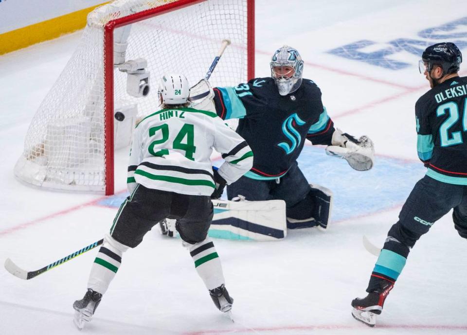 Dallas Stars center Roope Hintz (24) watches teammate Jamie Benn’s goal past Hintz and Kraken goaltender Phillip Grubauer during the first period of Game 4 of the Western Conference semifinals of the 2023 Stanley Cup Playoffs at Climate Pledge Arena in Seattle on May 9, 2023.