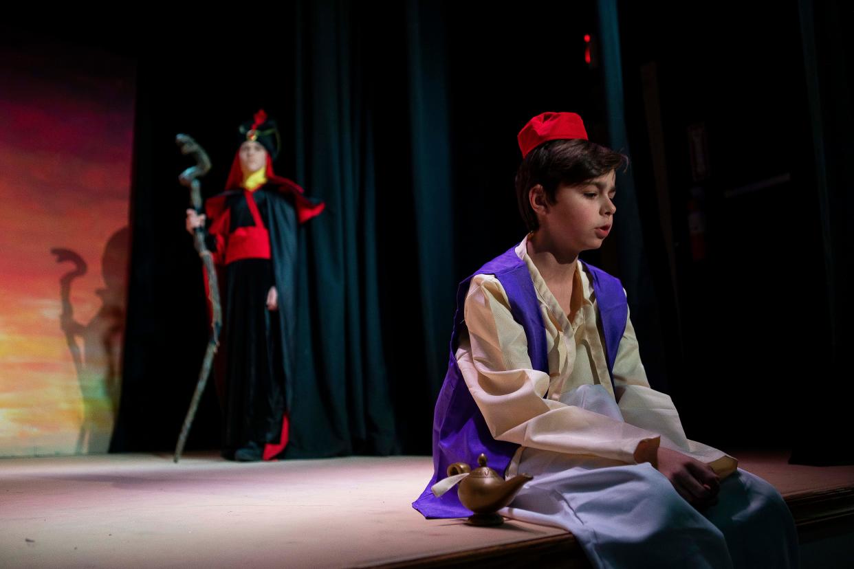 Sitting on the edge of the stage with a Genie lap Mark Yanko, 14, acts a scene during a dress rehearsal for the play Aladdin Jr. at the Chillicothe Civic Theater on Jan. 17, 2023 in Chillicothe, Ohio. The run dates for the play are Jan. 26 thru 29.