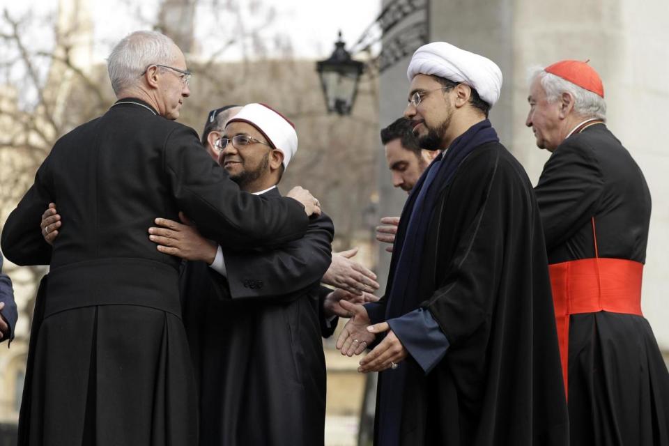 Coming together: The Archbishop of Canterbury, Justin Welby, left, embraces Sheikh Ezzat Khalifa as Sheikh Mohammad al Hilli and Cardinal Vincent Nichols, Archbishop of Westminster (AP)