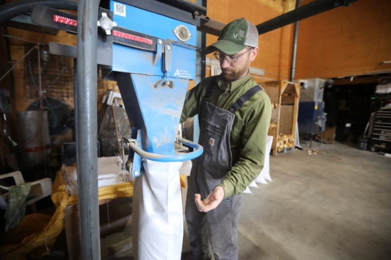 Farm manager fills bags of chicken feed at the Yukon Grain Farm near Whitehorse