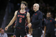 Utah coach Craig Smith talks with guard Jaxon Brenchley during the first half of the team's NCAA college basketball game against Southern California in Los Angeles, Wednesday, Dec. 1, 2021. (AP Photo/Alex Gallardo)