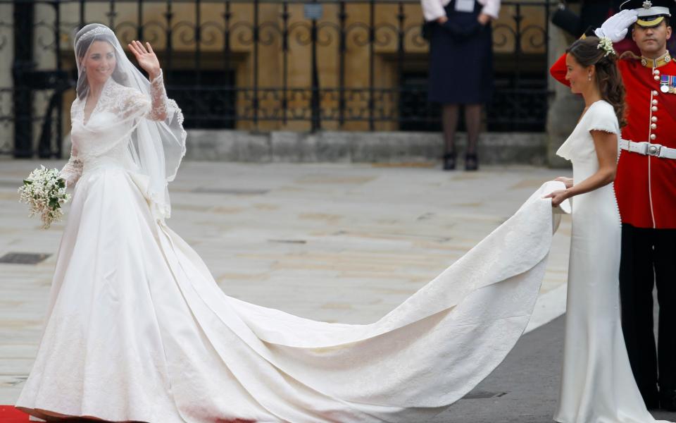 This Friday, April 29, 2011 photo shows Kate Middleton accompanied by maid of honour Pippa Middleton, right, as she arrives at Westminster Abbey at the Royal Wedding in London. - Credit: Alastair Grant/AP