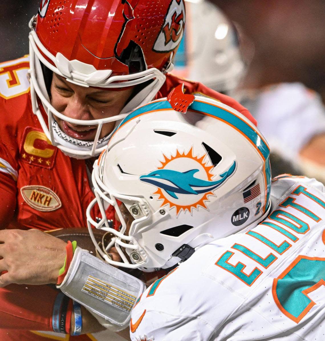 The helmet of Kansas City Chiefs quarterback Patrick Mahomes (15) breaks while being hit by Miami Dolphins safety DeShon Elliott (21) on a run in the third quarter Saturday, Jan. 13, 2024, at GEHA Field at Arrowhead Stadium.