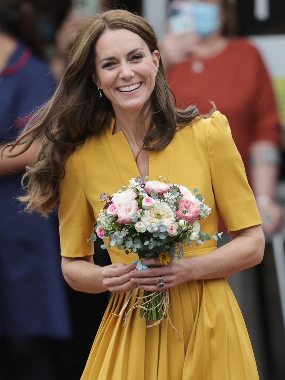 <p>Kate Middleton smiles after receiving a bouquet following her visit to the maternity ward of the Royal Surrey County Hospital in Guildford, England, on Oct. 5. </p>