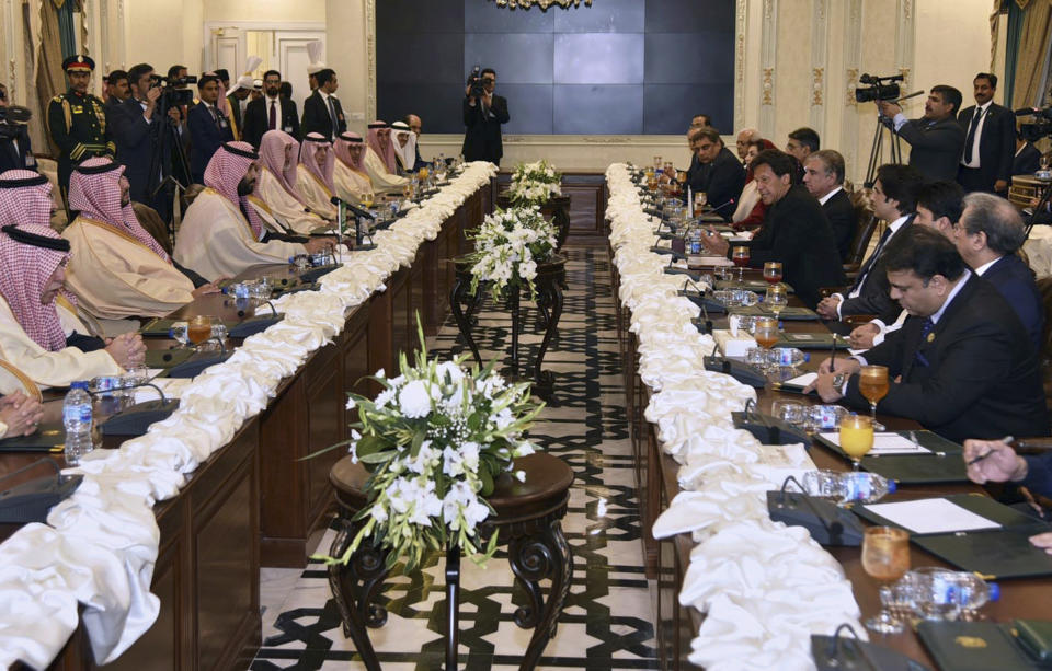 In this photo released by the Pakistan's Press Information Department, visiting Saudi Arabia's Crown Prince Mohammed bin Salman, fourth left, holds official talks with Pakistani Prime Minister Imran Khan, fifth right, in Islamabad, Pakistan, Sunday, Feb. 17, 2019. Saudi Arabia's powerful Crown Prince Mohammed bin Salman began his four-day regional visit on Sunday, arriving in Pakistan where he is expected to sign agreements worth billions of dollars to help the Islamic nation overcome its financial crisis. (Press Information Department via AP)