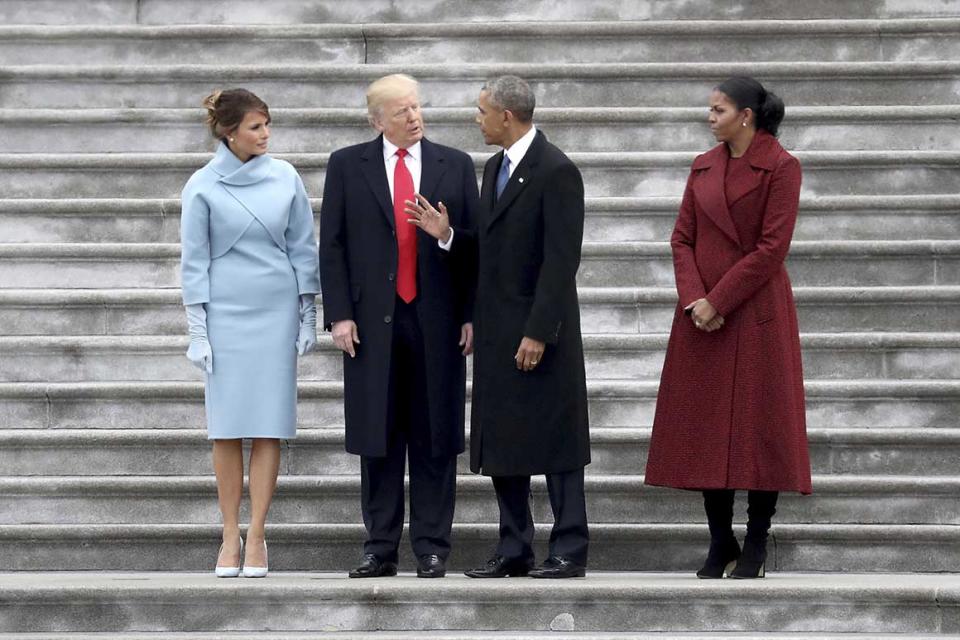 FILE - In this Friday, Jan. 20, 2017 file photo, from left, first lady Melania Trump, President Donald Trump, former president Barack Obama and Michelle Obama stand on the steps of the U.S. Capitol in Washington, after Trump's inauguration ceremony. On Tuesday, Feb. 20, 2018, The Associated Press has found that stories circulating on the internet that Trump canceled federal funding for former President Obama’s library are untrue. Private donations are paying for the library’s construction and it won’t be part of a network of presidential libraries administered by the National Archives. (Rob Carr/Pool Photo via AP)