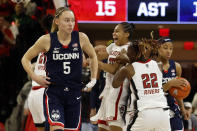 UConn's Paige Bueckers (5) walks off the court as North Carolina State players celebrate after an NCAA college basketball game Sunday, Nov. 12, 2023, in Raleigh, N.C. (AP Photo/Karl B. DeBlaker)