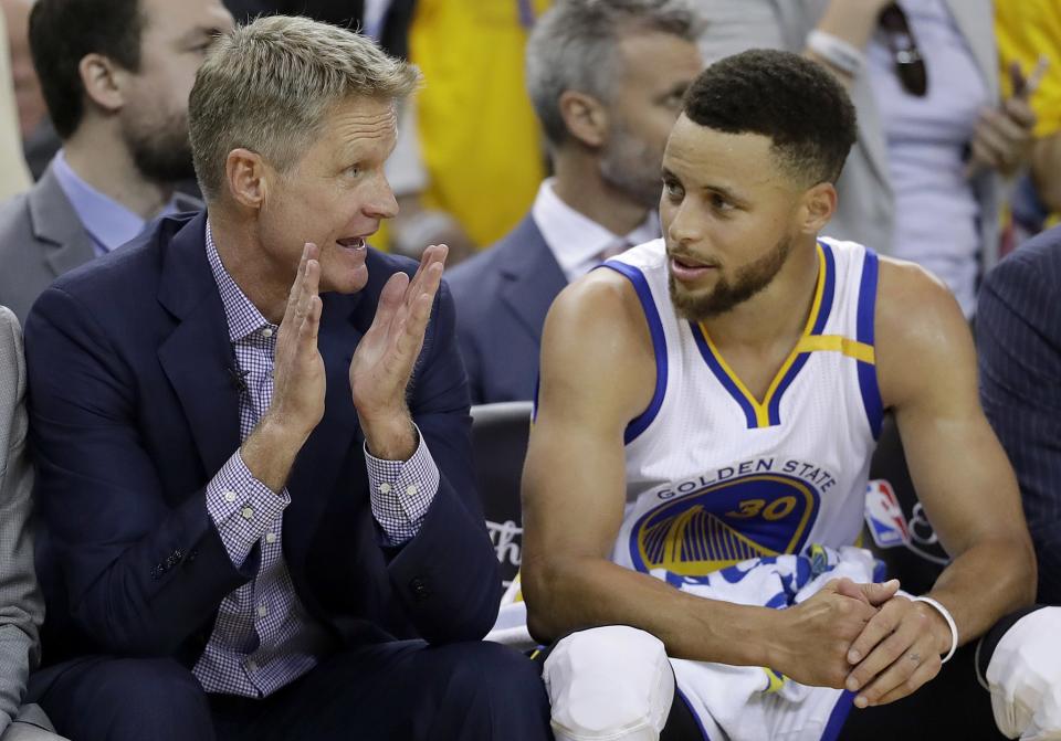 Steve Kerr (left) had missed the Warriors' previous 11 playoff games before returning to the sideline for Game 2 of the NBA Finals. (AP)