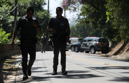 Policemen patrol a road, where they faced a gang after attempting an armed bank robbery in Guararema, near Sao Paulo, Brazil April 4, 2019. REUTERS/Amanda Perobelli