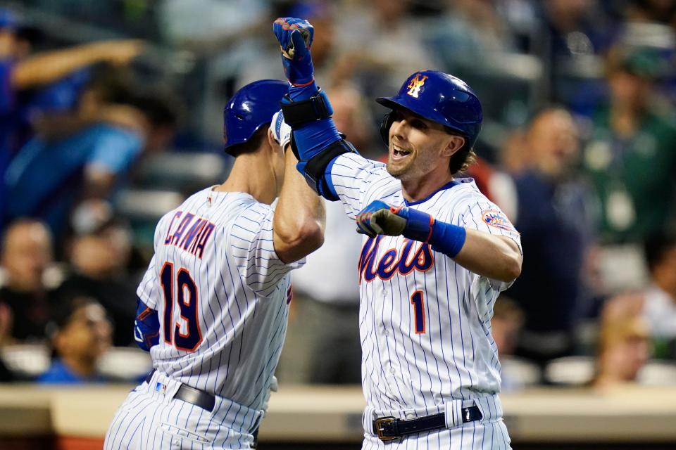 New York Mets' Jeff McNeil (1) celebrates with teammate Mark Canha after hitting a home run during the fourth inning of a baseball game against the Milwaukee Brewers, Wednesday, June 15, 2022, in New York.