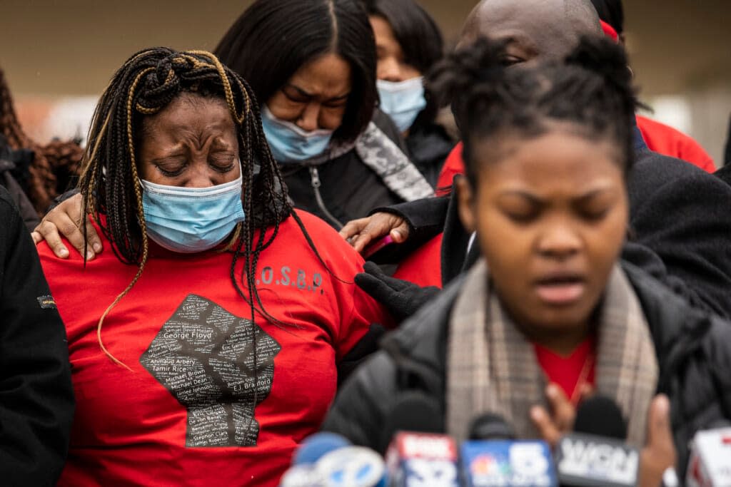 Clifftina Johnson, back left, Tafara Williams’ mother, cries as her daughter, Sasha Williams, sings during a press conference outside City Hall in Waukegan, Ill., Tuesday, Oct. 27, 2020. (Ashlee Rezin Garcia/Chicago Sun-Times via AP, File)