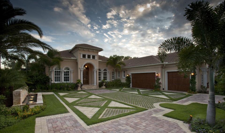 This undated photo provided by Busk & Associates Inc. shows a living driveway. In Naples, Fla., landscape architect W. Christian Busk installs “living driveways,” which feature real grass interspersed among pavers, which reduces heat and glare and provides some drainage. (AP Photo/ Busk & Associates, Inc., W. Christian Busk Landscape Architect, Inc.)