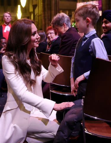 <p>CHRIS JACKSON/POOL/AFP via Getty</p> The Princess of Wales met young guest Oscar Burrow, 7, at the carol concert