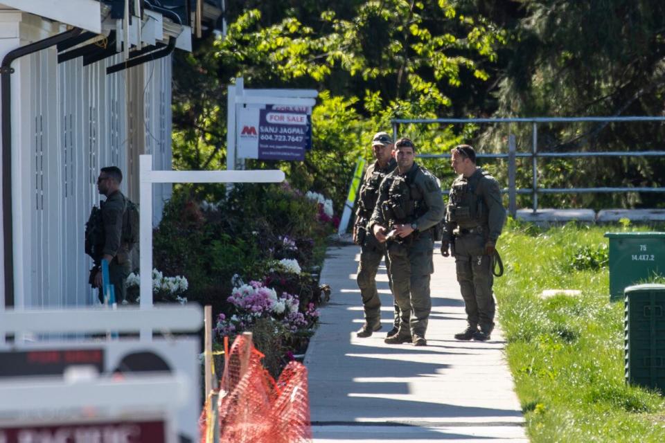 RCMP Emergency Response Team (ERT) police officers are pictured near a home on in South Surrey on Monday. (Ben Nelms/CBC - image credit)