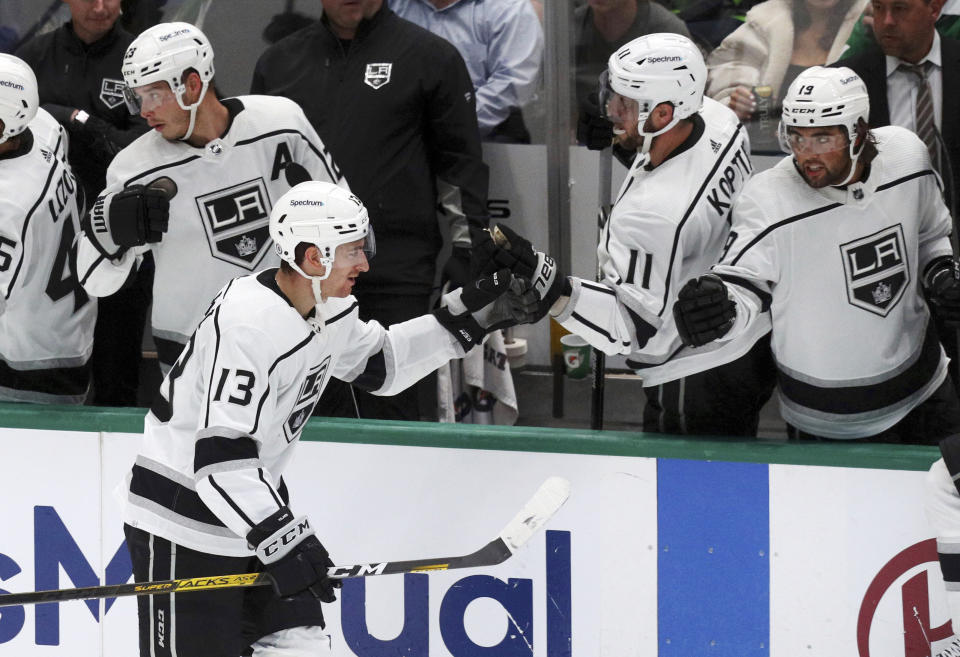 Los Angeles Kings center Gabriel Vilardi (13) fist-bumps Anze Kopitar (11) after scoring a goal against the Dallas Stars during the second period of an NHL hockey game Friday, Oct. 22, 2021, in Dallas. (AP Photo/Richard W. Rodriguez)