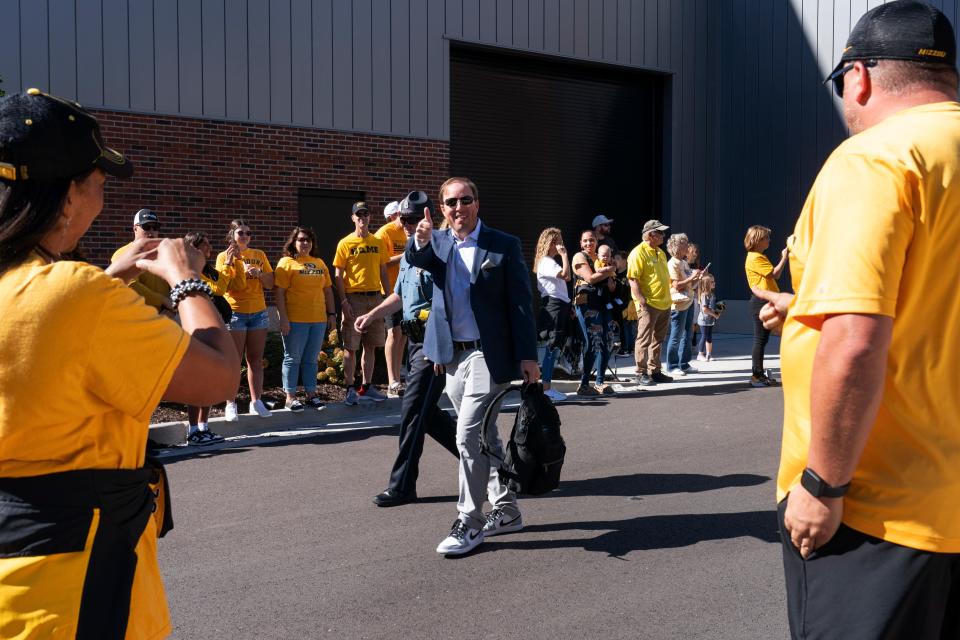 Missouri head coach Eliah Drinkwitz waves at fans as he enters the stadium before the start of an NCAA college football game against South Carolina Saturday, Oct. 21, 2023, in Columbia, Mo. (AP Photo/L.G. Patterson)