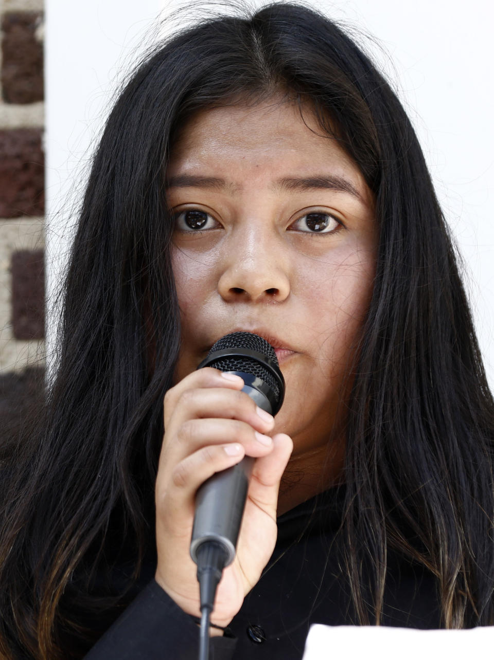 Dulce Basurto-Arce, of Canton, Miss., speaks of why some parents seeking a better life for their children break the law and get arrested, during a protest march at the Madison County Courthouse in Canton, Miss., Sunday, Aug. 11, 2019. The protest was by mainly Latino children who marched from an area church to the courthouse in support of their immigrant parents and individuals picked up during an immigration raid at a poultry processing plant in Canton and other mid-Mississippi poultry plants. (AP Photo/Rogelio V. Solis)