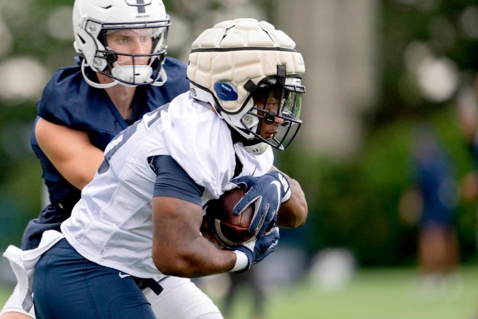 Penn State running back Caziah Holmes cuts the ball during the first day of practice on Monday, Aug. 1, 2022.