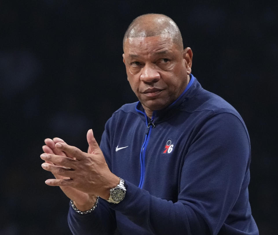 FILE - Philadelphia 76ers head coach Doc Rivers claps during the first half of Game 4 in an NBA basketball first-round playoff series against the Brooklyn Nets, April 22, 2023, in New York. ESPN let NBA analyst Mark Jackson go Monday, July 31, 2023, with two years remaining on his contract. With Jeff Van Gundy also being laid off in late June, ESPN is expected to replace them with Rivers and Doris Burke, people close to the move told The Associated Press. (AP Photo/Frank Franklin II, File)