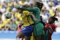 <p>Brazil goalkeeper Barbara, center, fails to grabs the ball as her teammate Monica, left, jumps during the bronze medal match of the women’s Olympic football tournament between Brazil and Canada at the Arena Corinthians stadium in Sao Paulo, Friday Aug. 19, 2016. (AP Photo/Nelson Antoine) </p>