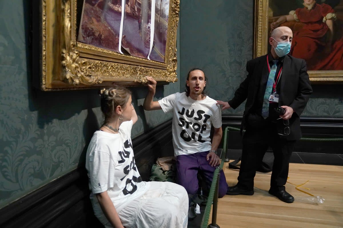 Protesters from Just Stop Oil covered John Constable’s The Hay Wain with their own picture inside the National Gallery, London (PA Wire)