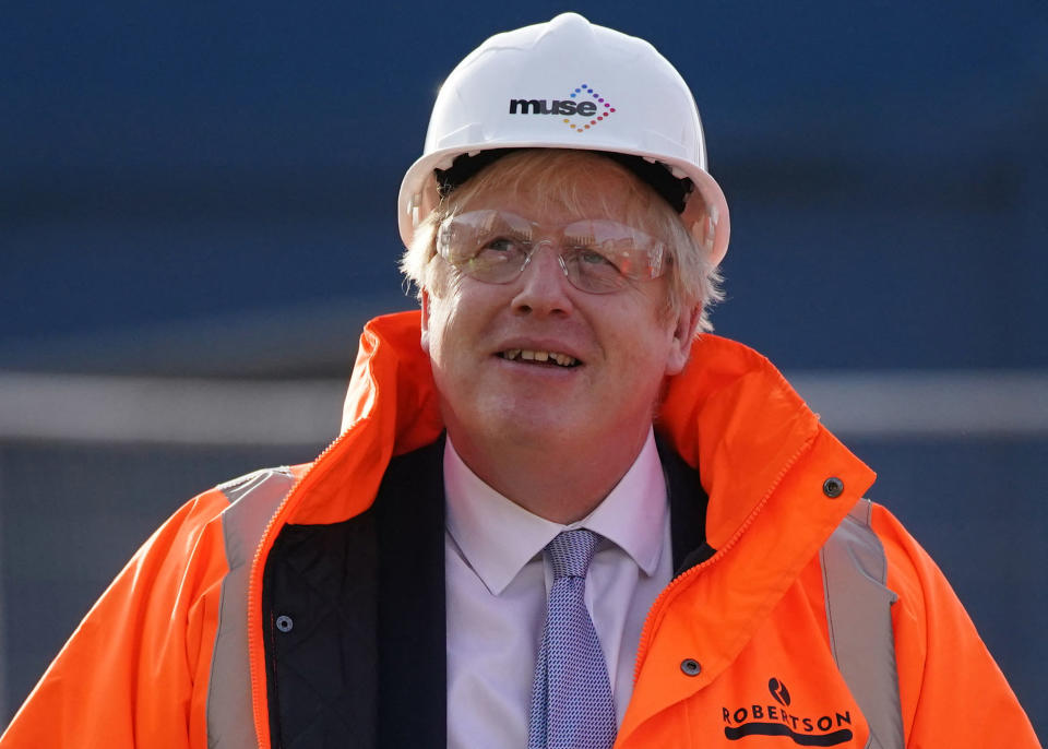 Britain's Prime Minister Boris Johnson, wearing safety glasses and a hard hat, reacts during a visit to Talbot Gateway in Blackpool, north-west England on February 3, 2022. - The British government has unveiled a vast plan aimed at 