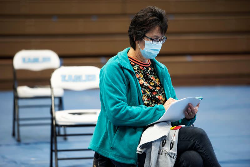 People from rural communities get their coronavirus disease (COVID-19) vaccinations at Menominee Indian High School in Menominee, Wisconsin