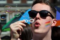 A man blows bubbles as supporters for same-sex marriage gather at Dublin Castle on May 23, 2015 in Dublin