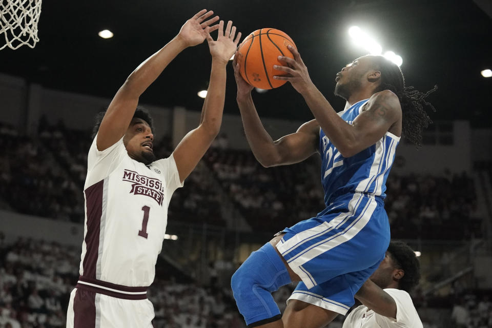 Kentucky guard Cason Wallace (22) attempts a layup as Mississippi State forward Tolu Smith (1) defends during the first half of an NCAA college basketball game in Starkville, Miss., Wednesday, Feb. 15, 2023. (AP Photo/Rogelio V. Solis)