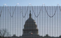 Fencing and razor wire surrounds the perimeter of the Capitol in Washington, Thursday, Feb. 25, 2021. (AP Photo/J. Scott Applewhite)