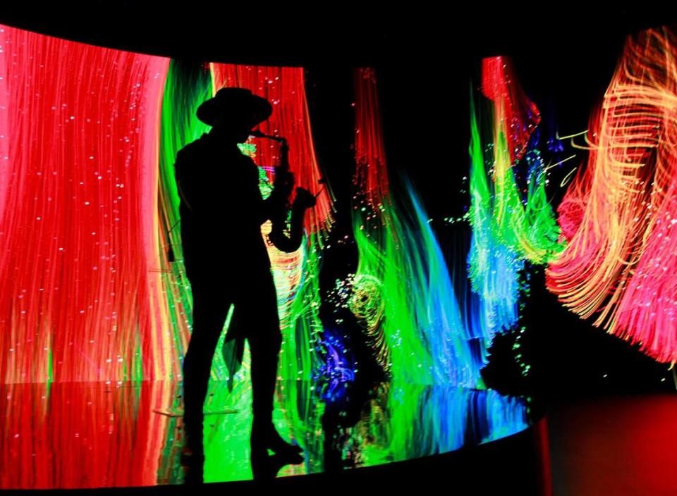 David Rodriguez plays the saxophone while attendees mingle after the unveiling of the Virtual Production LED Wall that is a the result of a collaboration between GRUP MEDIAPRO and BrandStar Studios on Tuesday, June 20, 2023 at the Mediapro studio in Medley, FL.